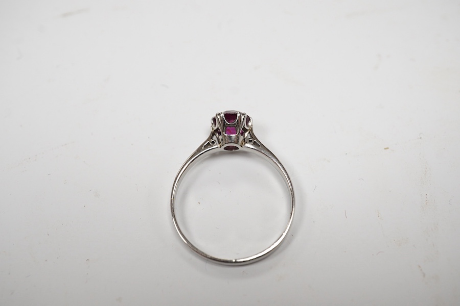 A white metal (stamped plat) and solitaire ruby set ring, size L, gross weight 2.2 grams. Condition - poor to fair